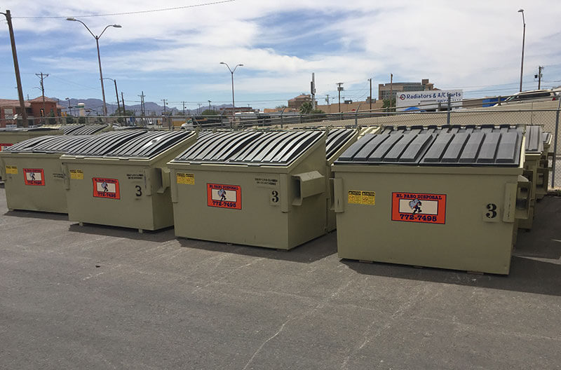 Photo of a row of Commercial Dumpsters.